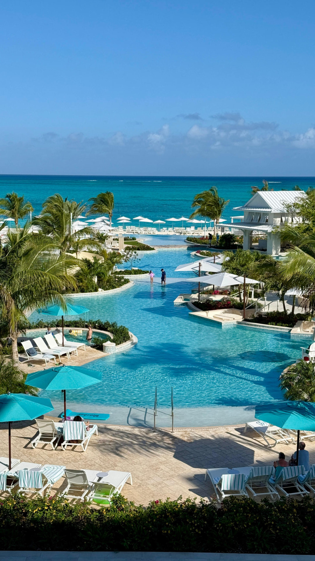 A turquoise resort pool stretching toward the Caribbean sea at a Beaches resort
