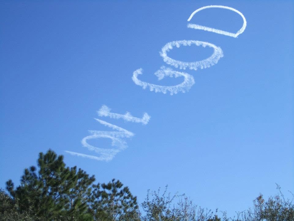 Skywriting reading Love God in a clear blue sky