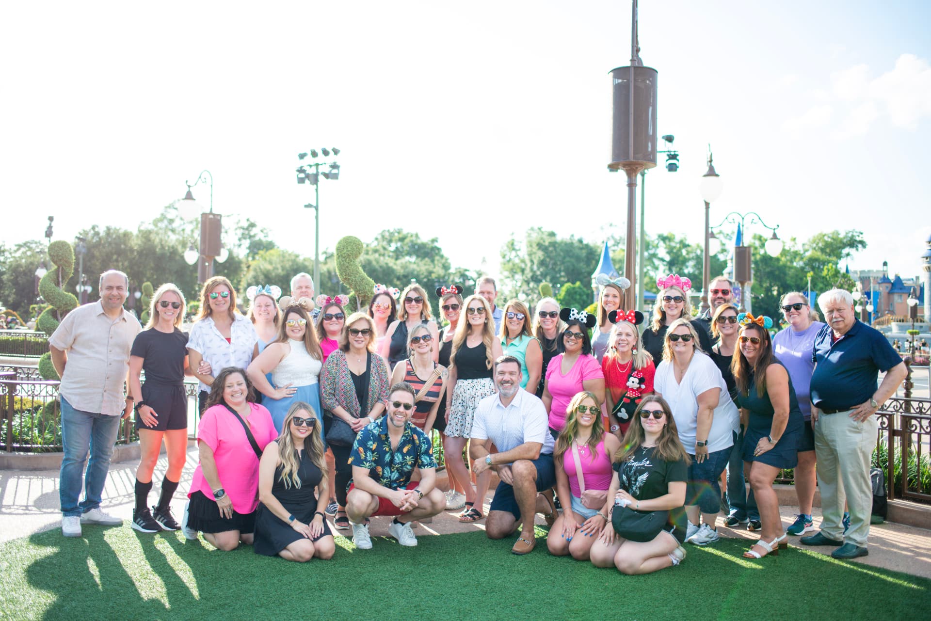A group of travelers celebrating together at a Disney park