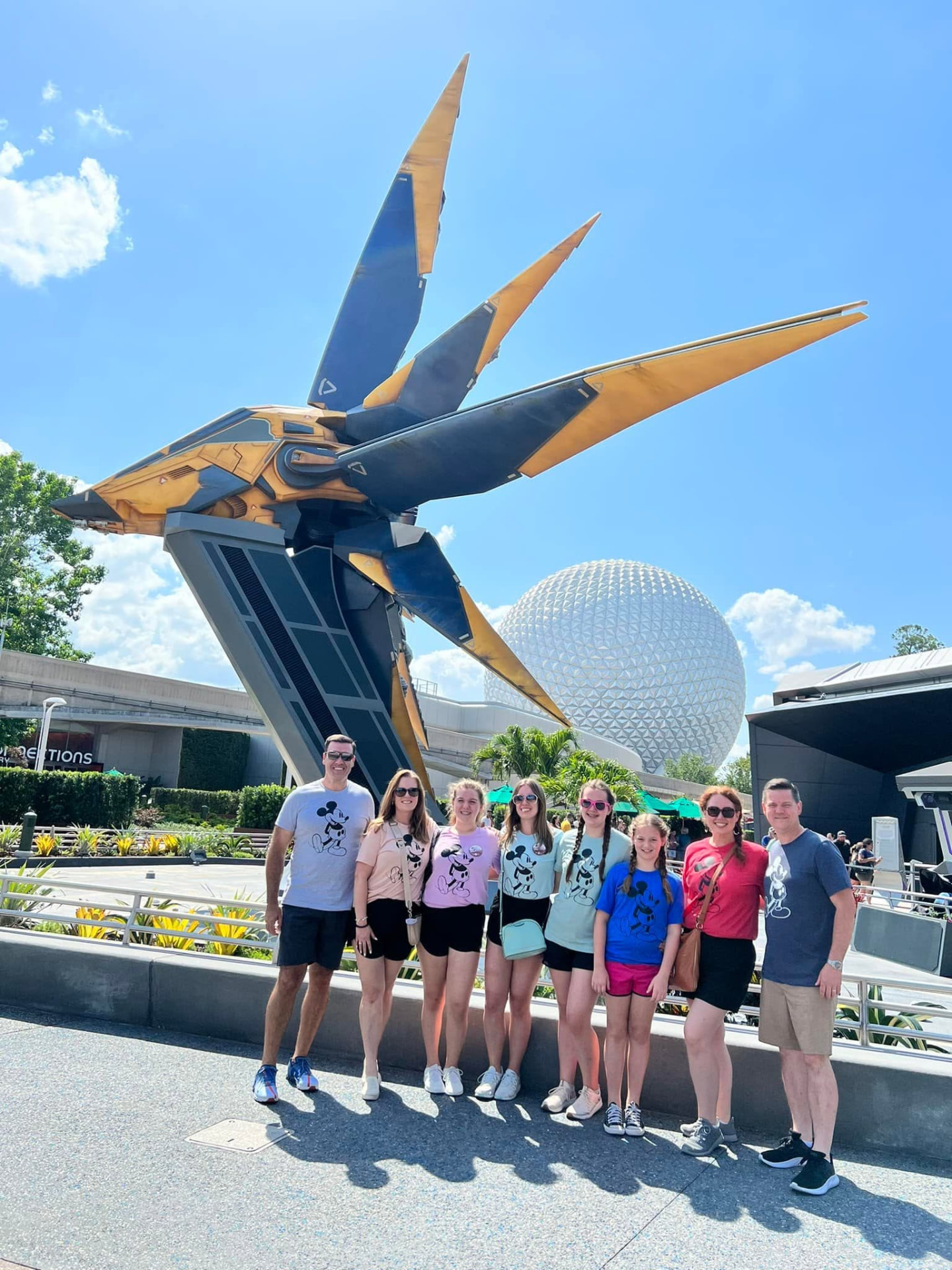 Two families in matching shirts together at EPCOT