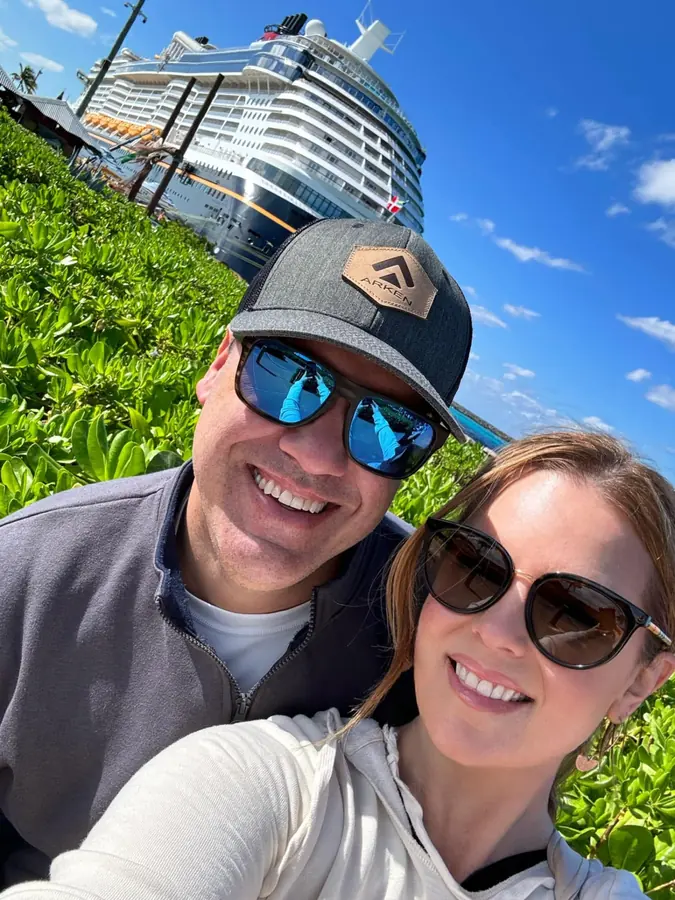 Brandon and Ashlee in front of a Disney Cruise Line ship