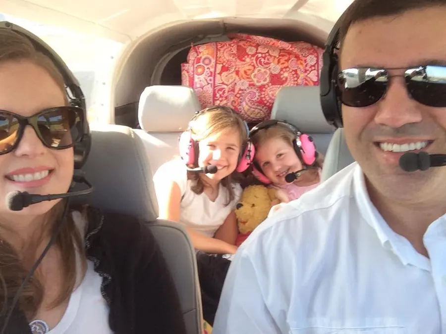 The family in headsets aboard a small plane